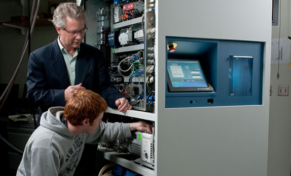 Xemed CEO Bill Hersman checks polarizer status with undergraduate intern Igor Tsentalovich