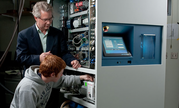 Xemed CEO Bill Hersman checks polarizer status  with undergraduate intern Igor Tsentalovich